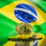 Bitcoin coin with Brazil flag in the background